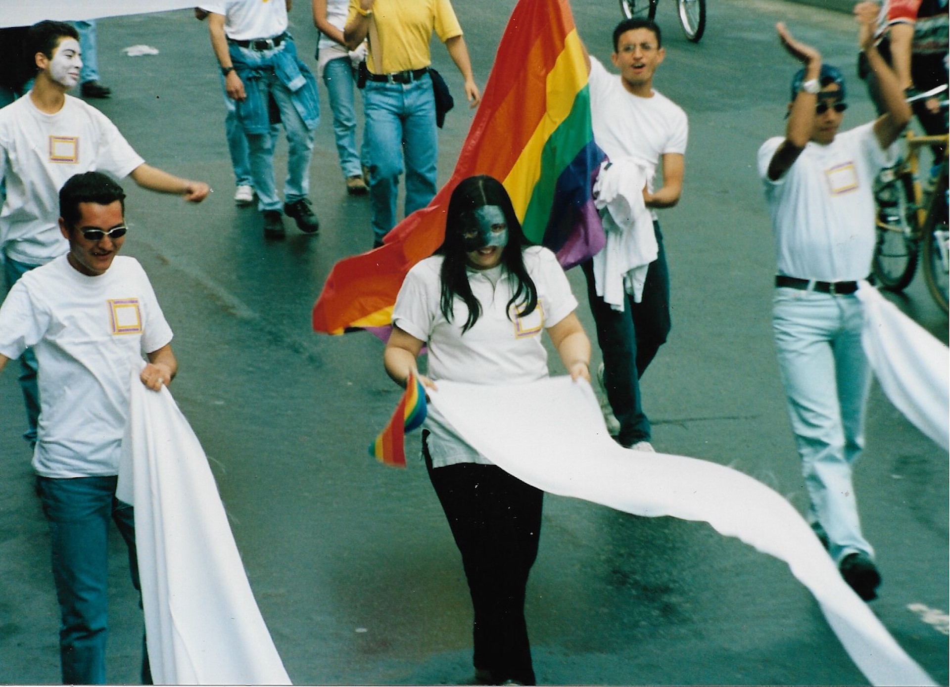 Marchantes de blanco con la bandera de la diversidad